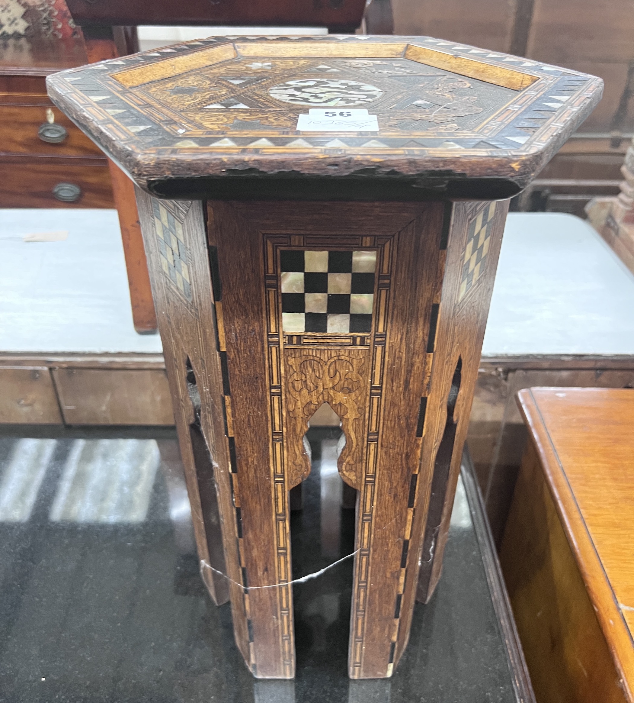 A Moorish mother of pearl inlaid hexagonal occasional table, width 32cm, height 46cm